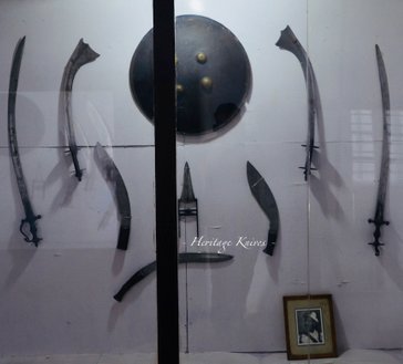 heritage knives Nepal, kukri, khukuri, semi-custom knife maker, National arsenal museum of Nepal, kathmandu, gallery collection of antique weapons. history and heritage series, palace, durbar, notes, blades, swords, battles, war, gorkhali, malla, gurkhas, gorkha, military history, army, nepal, british, india, tibet, china, colonial, mir kasim, sino-nepal war, conquest of Kathmandu, Bhaktapur, Ranjit malla, ochterlony, young, fraser, thappa, balbhadra, bulbudder kunwar, amar singh thapa, jung bahadur rana, bir Narsingh kunwar, chandra Shumsher rana, maharaja, king, raja, tulwar, kora, axe, katar, chinese, mughal, indian, european, chandra shumsher, prithivi shah, prithvi narayan, nayan singh, kaji, bhimshen thapa, mukhtiyar, prime minister, jagat jung, bir shumsher, dev sjb rana, jit jung rana, mathber singh thapa, abhiman singh basnyat, kami, brahmin, thakuri, chettri, magar, gurung, tamang, kami, dalit, muslim, hindu, buddhist, Tibetan, art, art work, traditional weapons, Asian, Himalayas, ww1, ww2, world war, british empire, anglo-gorkha, anglo-nepal war, Khalanga Nalapani, Jaithak, Sirmoor, Nusseree, devi dutta, purano gorakh, sri nath, rifles, guns, London, traditional, Dravya shah, liglig kot, Lamjung, kirant, kirat, newar, Chaubise, baise, Tibet, Himalayas, kilatools.com, ang khola, papu, purano, sirupate, Budhume, Bhojpure, bas pate, style, broad belly, army issue, historical, old, image, photo, chirra, Hanshee, Lambendh, curved, antiques, reproduction, Gorakhnath, myth, legends, kaji, khanda, walled city, defence, attack, pesh kabz, handle, wood, kirtipur, map, sardar ram krishna kunwar, kinloch expedition, sindhuli.